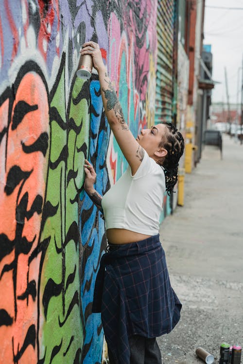 A Woman Spray Painting on the Wall