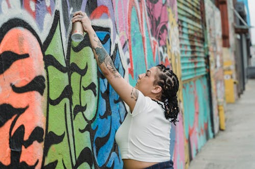 A Woman Spray Painting on the Wall