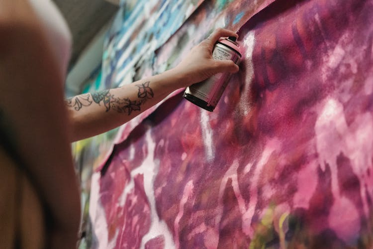 Close-up Of Person Painting Graffiti With Spray