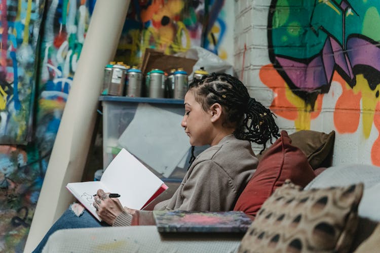 Woman Drawing Graffiti In A Notebook 