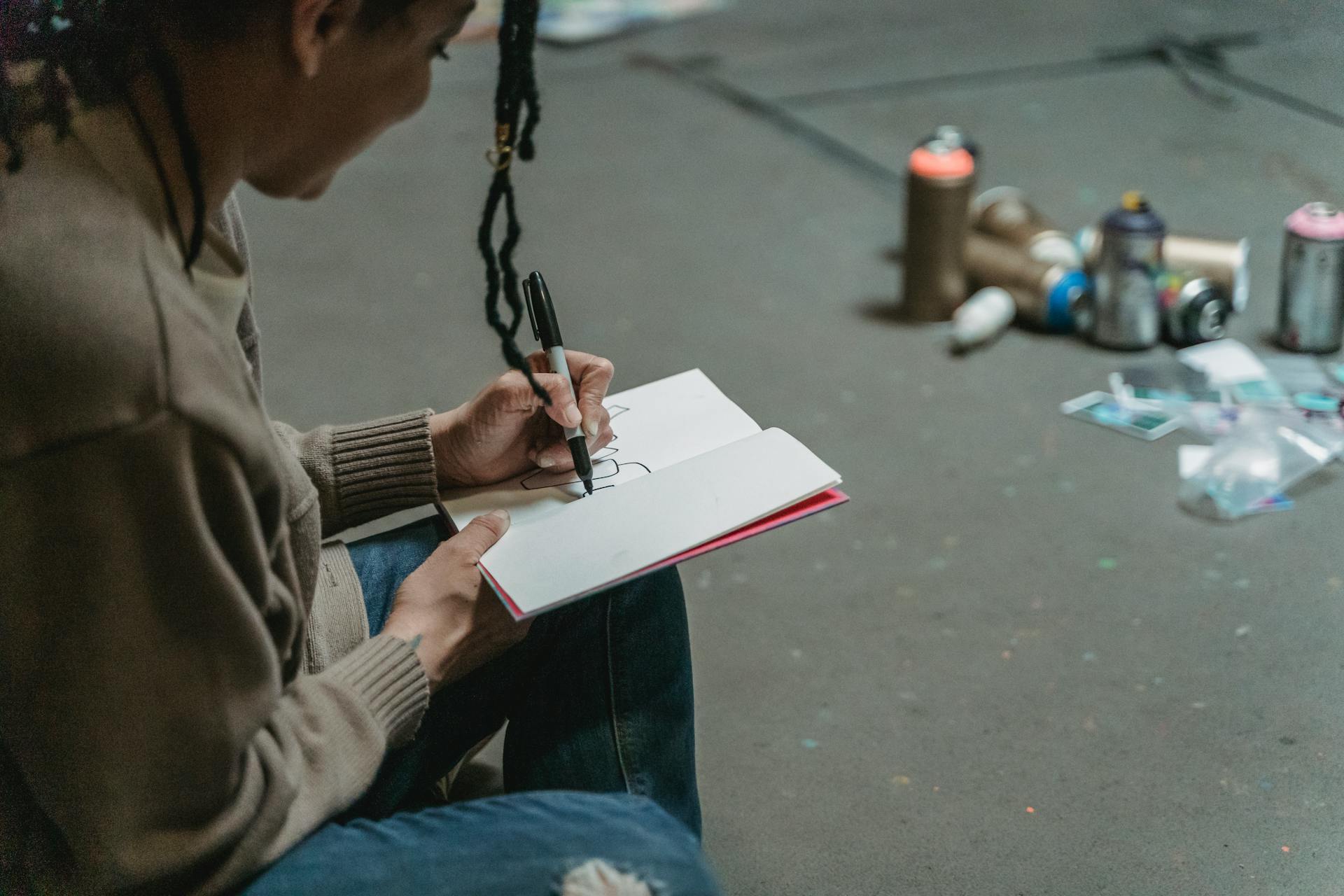 Woman Doodles in a Notebook