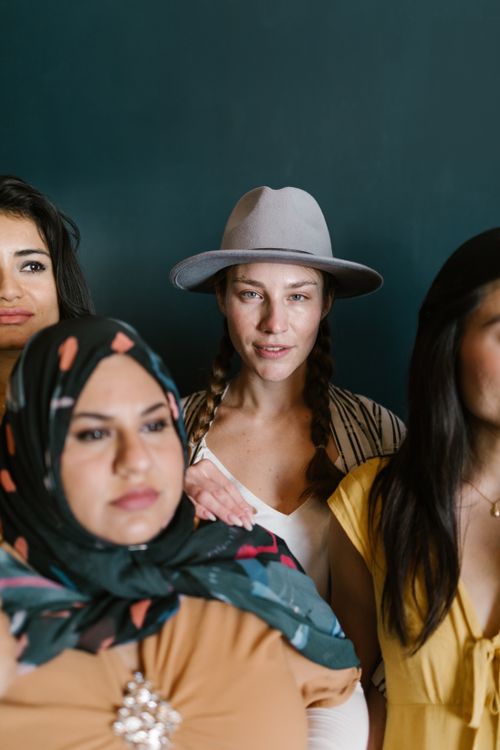Free Powerful portrait of diverse women exuding unity and empowerment indoors. Stock Photo
