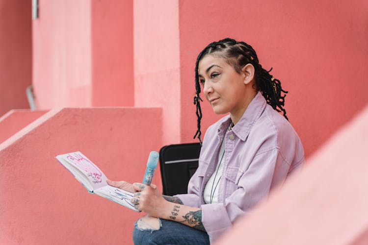 A Woman Writing In Notebook