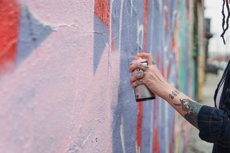 Close-up of a stencil being sprayed with a low-pressure can showing clean crisp edges