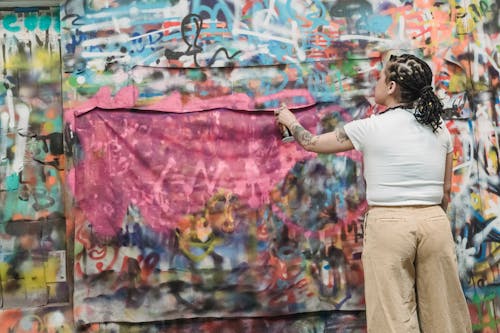 Free Woman Painting Graffiti on Wall Stock Photo