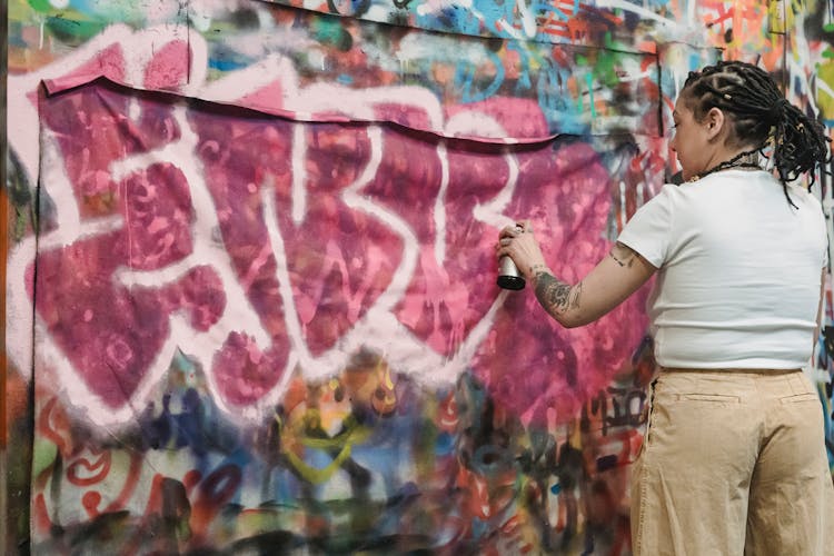 Person In White T-shirt Painting Graffiti