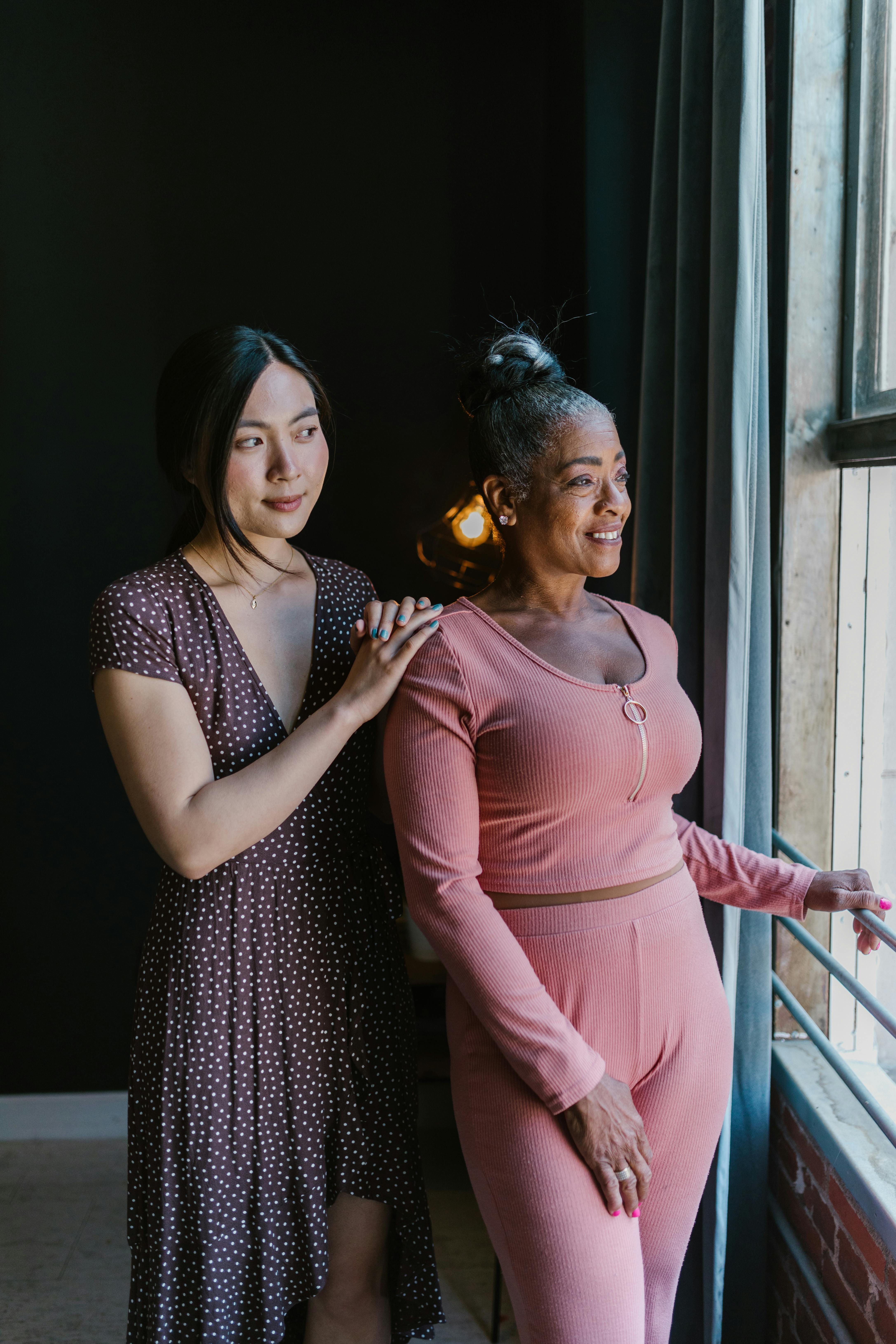 women looking at window pane