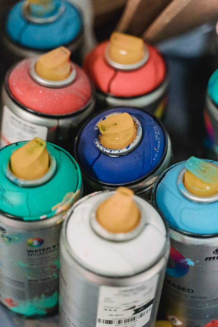 Spray Paints With Yellow Caps