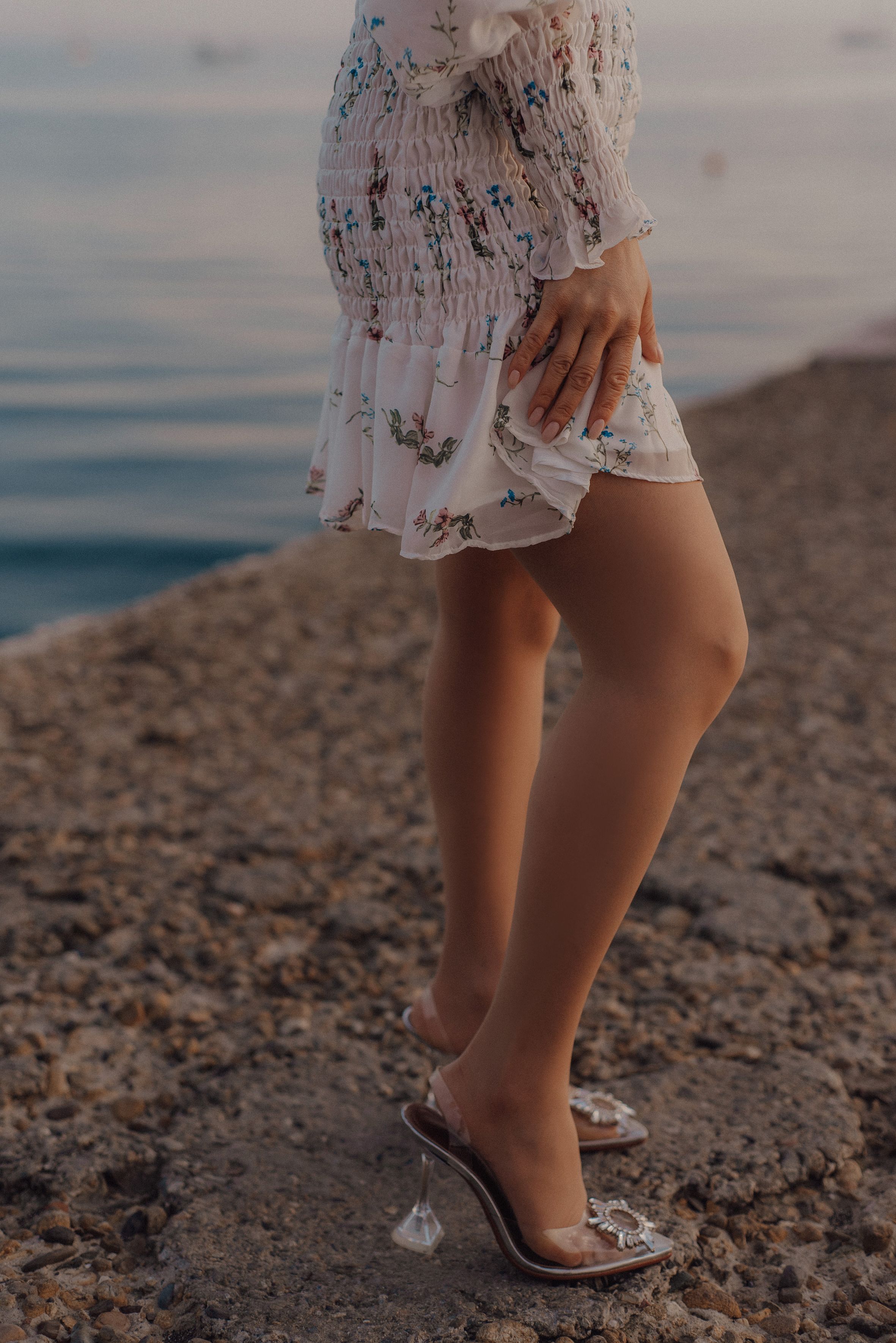 Woman wearing a floral tea dress with heeled mules