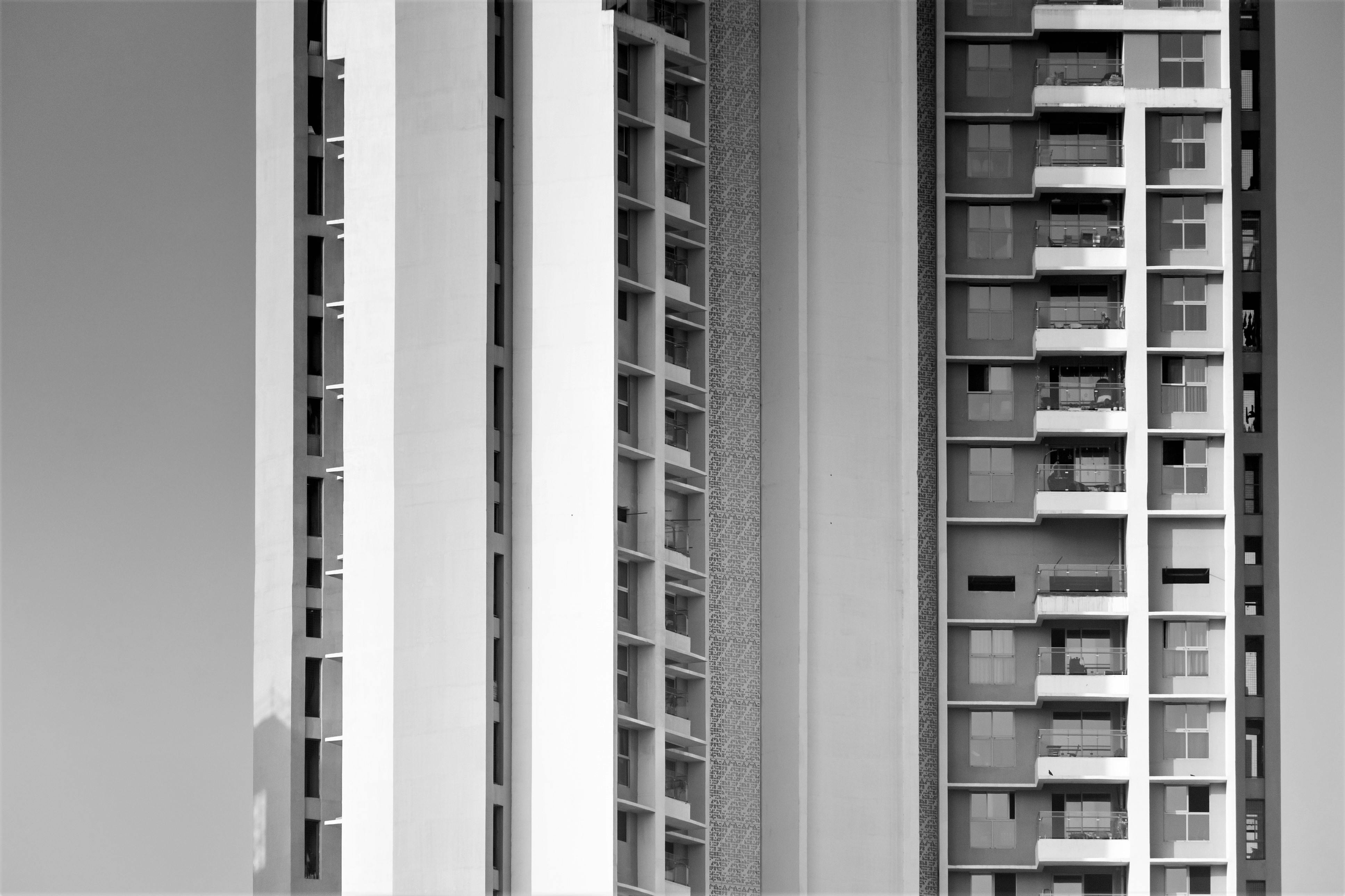 Black and white photograph of modern high-rise buildings in Mumbai, focusing on architectural details.