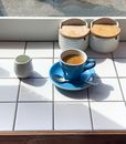 Blue and White Ceramic Teacup on Blue Saucer