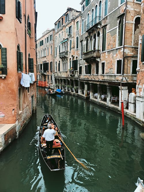 People Riding in a Gondola in a Venice Canal