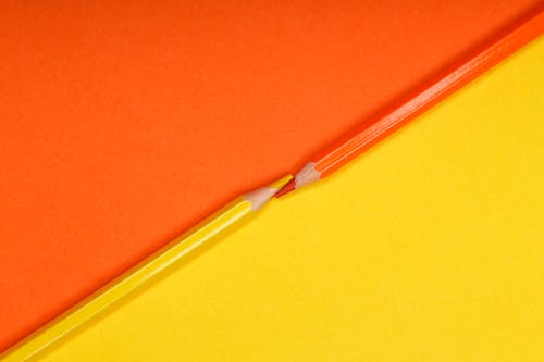 Close-Up Photo of Orange and Yellow Colored Pencils