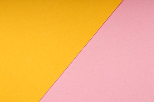 A vibrant abstract image featuring diagonal yellow and pink surfaces creating a minimalistic design.