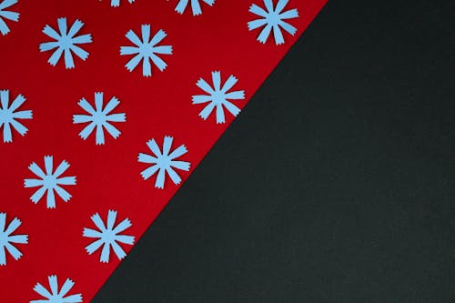 White Flower Cutouts on a Red and Black Surface