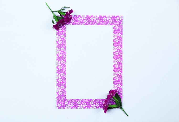 Empty Purple Picture Frame And Purple Flowers 