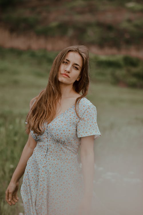 Woman in Floral Dress Standing in the Field