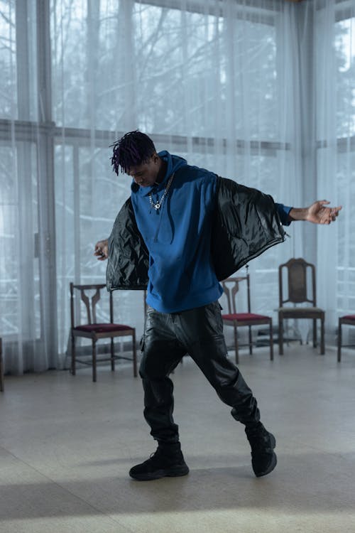 A Man wearing Blue Hoodie While Dancing 