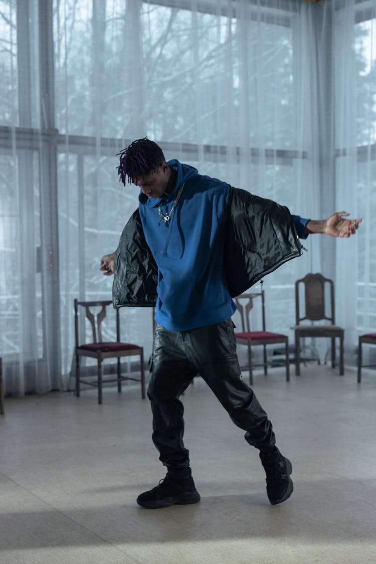 A Man Wearing Blue Hoodie While Dancing 