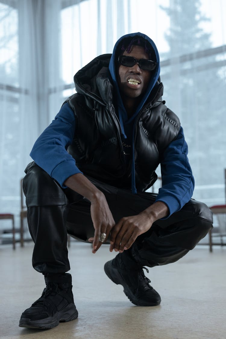 Man In Black Vest Crouching