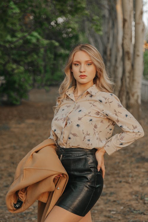 Trendy model with hand on hip in park