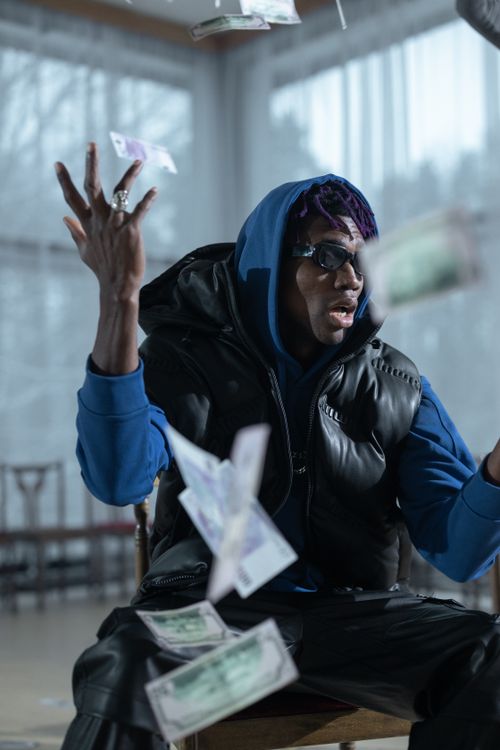 Free A fashionable man in sunglasses throwing banknotes indoors with a modern vibe. Stock Photo