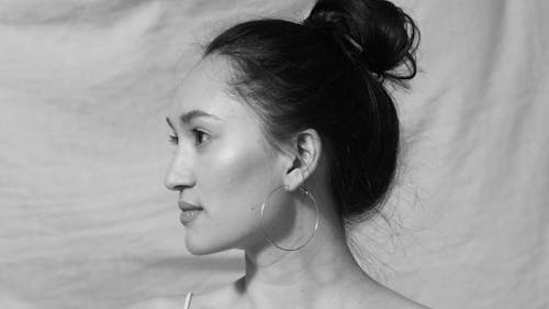 Black and White Photo of a Woman Wearing Hoop Earring