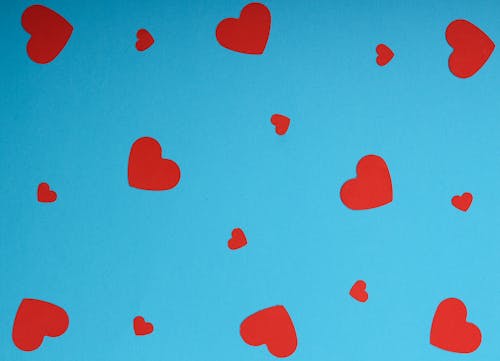 Red Heart Shapes on Blue Background