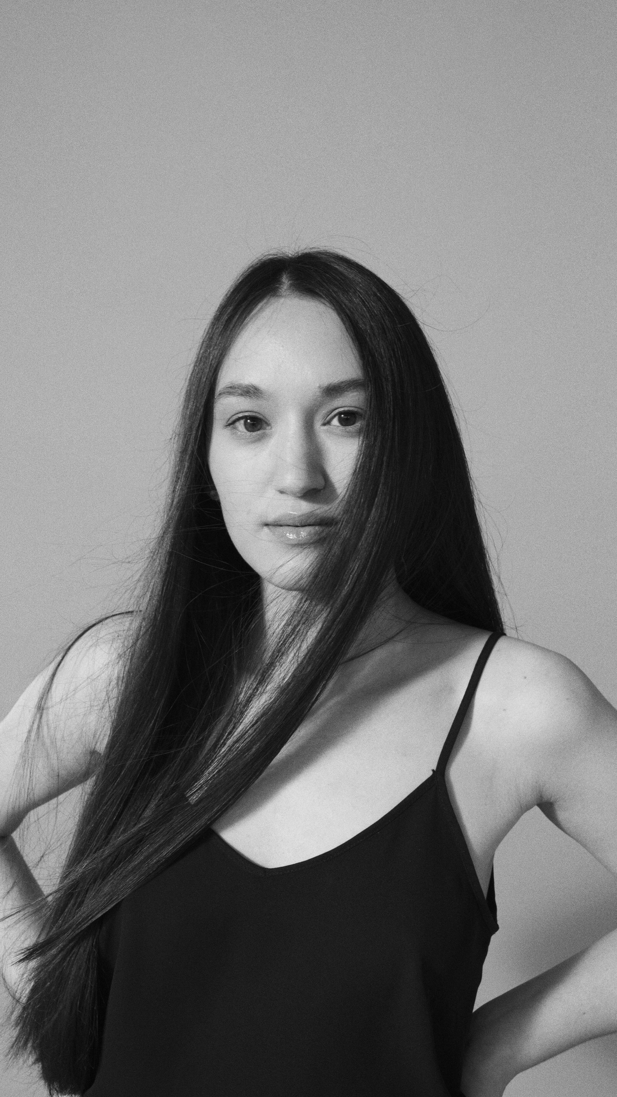 Elegant black and white portrait of a woman with a contemplative expression.
