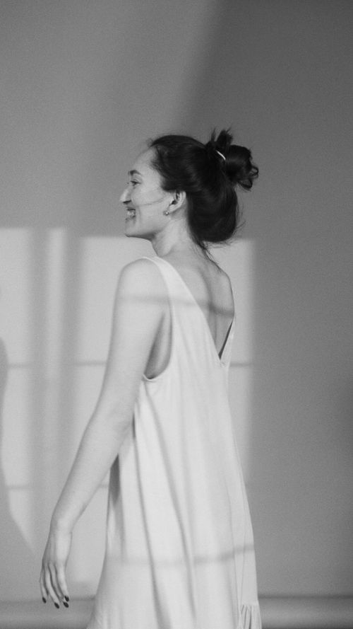 Free Black and white portrait of a woman smiling in a dress. Stock Photo