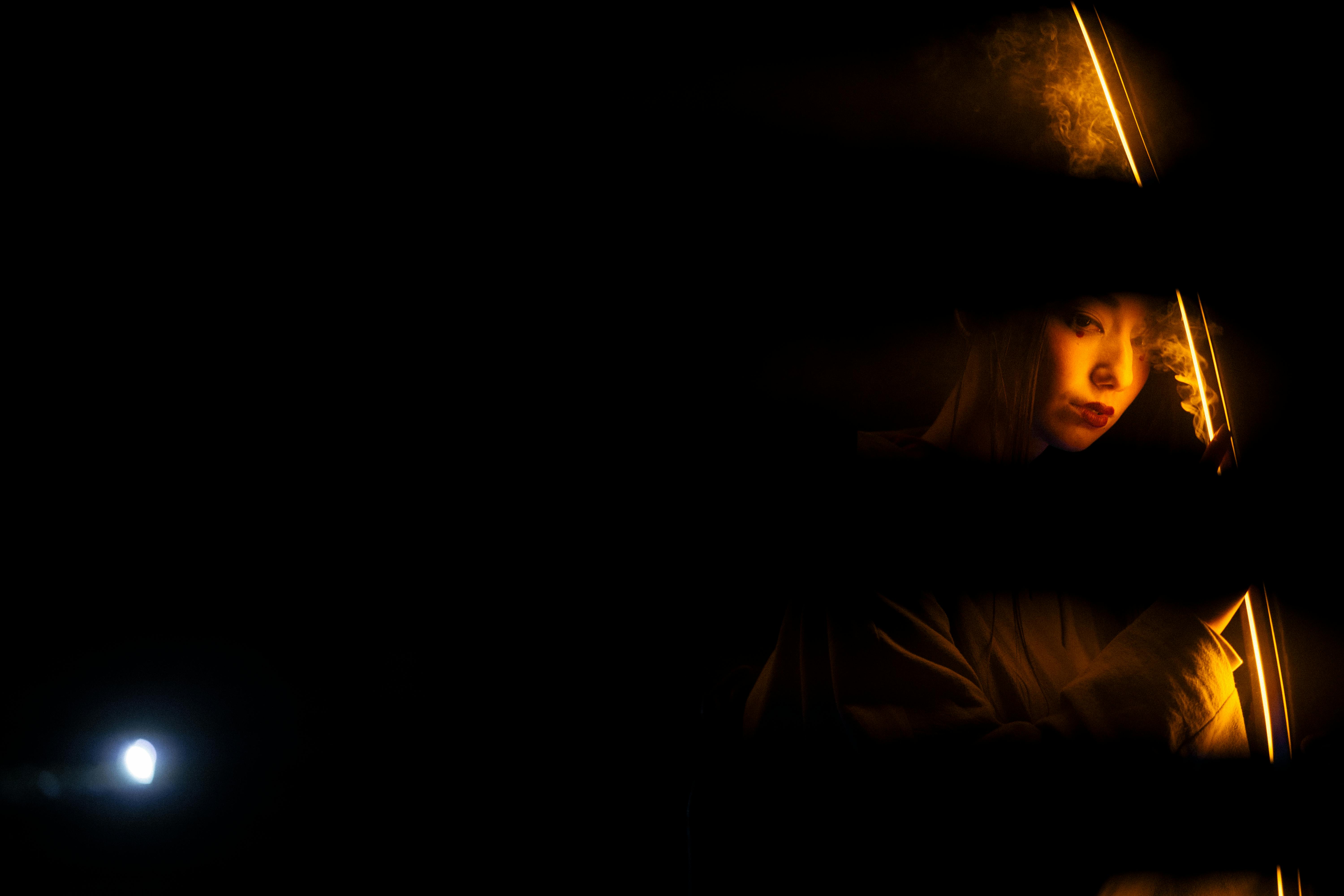 reflection of light on woman in black background