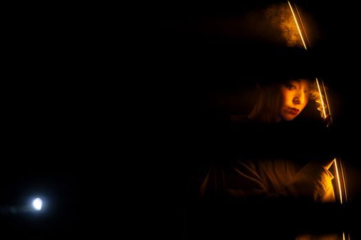 Reflection Of Light On Woman In Black Background