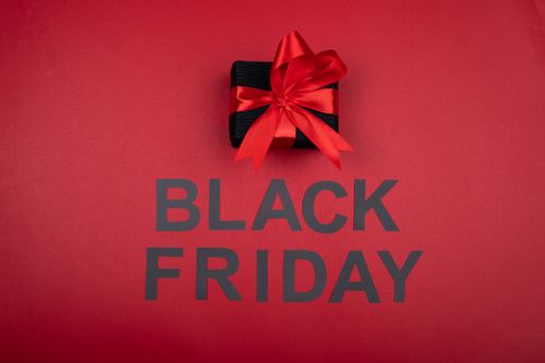 Free Black gift box with red ribbon, perfect for Black Friday sales promotions. Stock Photo