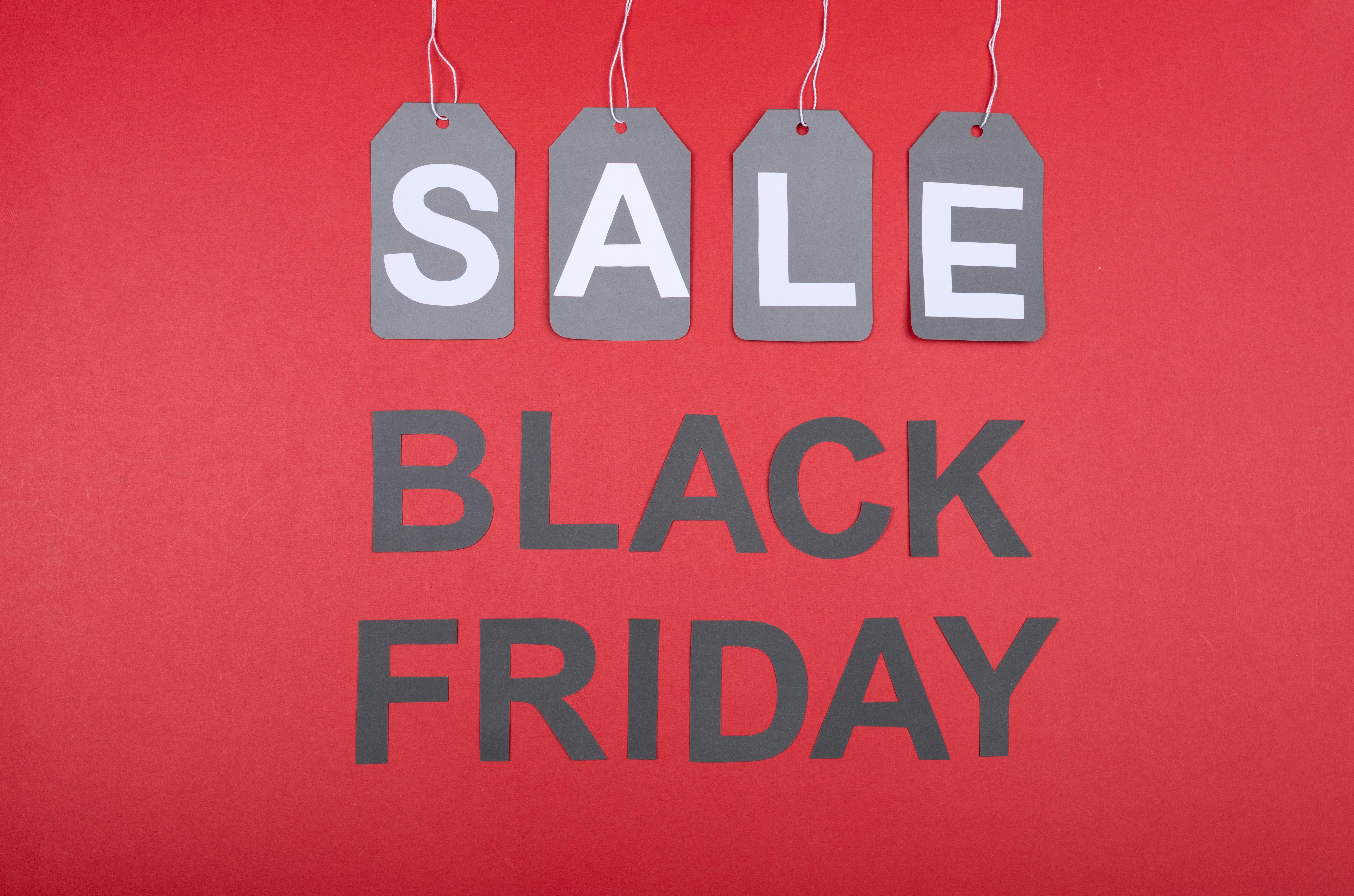 Red background with SALE tags and Black Friday text, ideal for promotions.