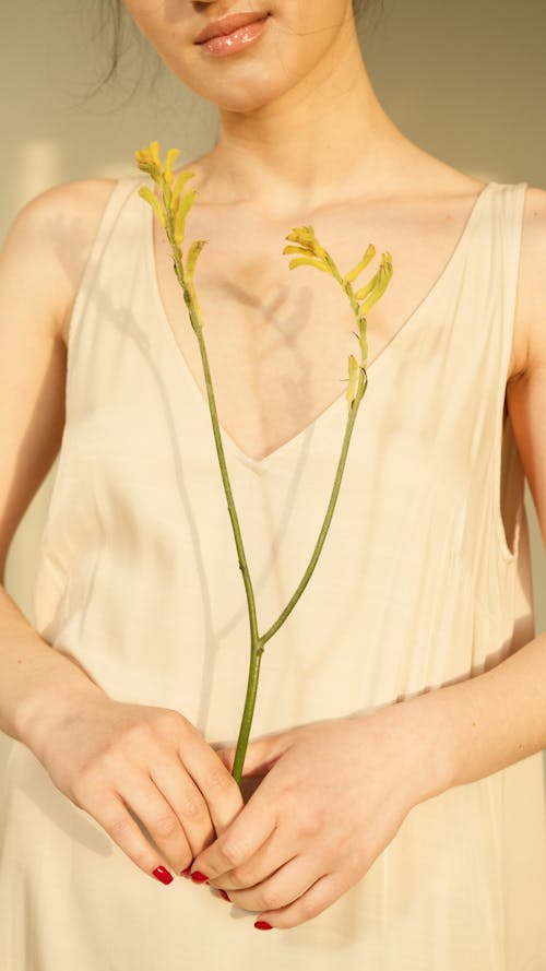 A Woman Holding Yellow Flowers