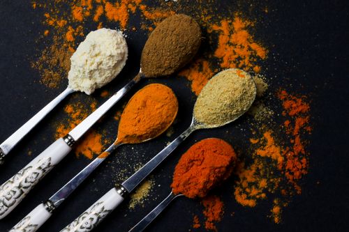 Free A vibrant array of spices on decorative spoons, showcasing culinary diversity. Stock Photo