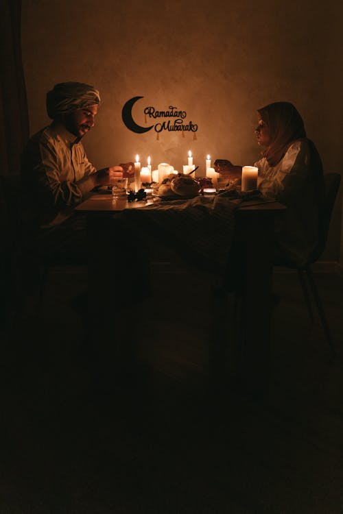 A Couple Having Dinner with Lighted Candles