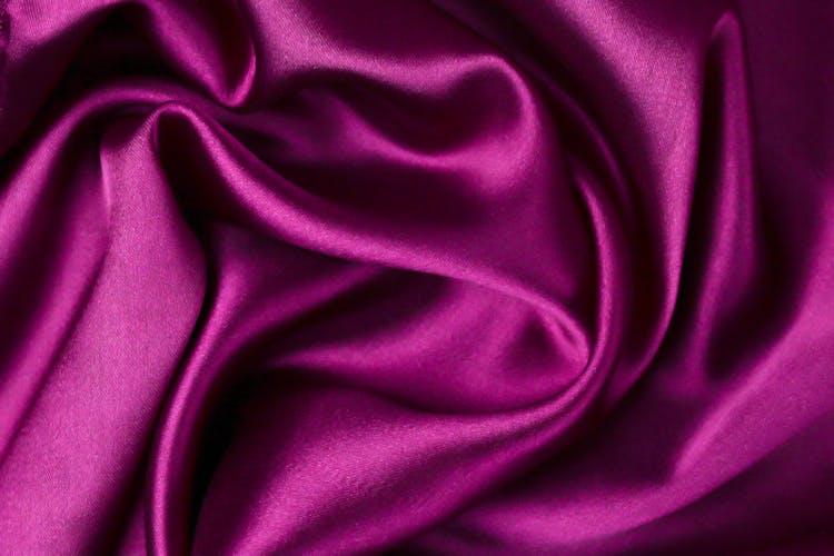 A Close-Up Shot Of A Magenta Satin Fabric