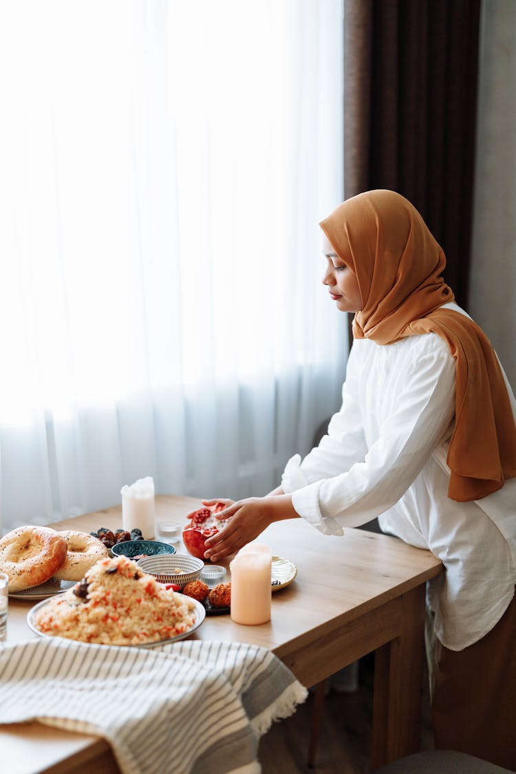 Woman Preparing The Table For A Meal 