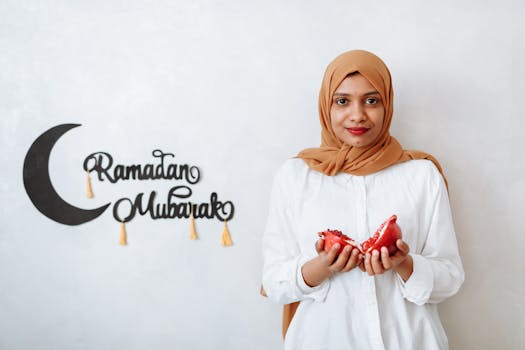 A woman in traditional wear holding a pomegranate, celebrating Ramadan indoors.