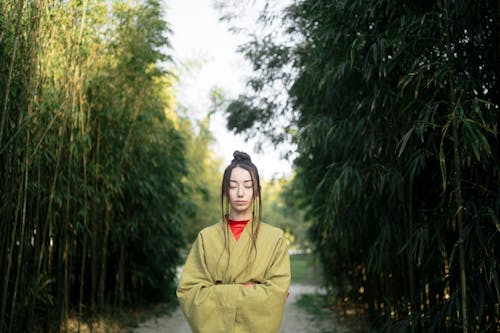 Free Woman in Green Kimono Standing Near Green Trees Stock Photo