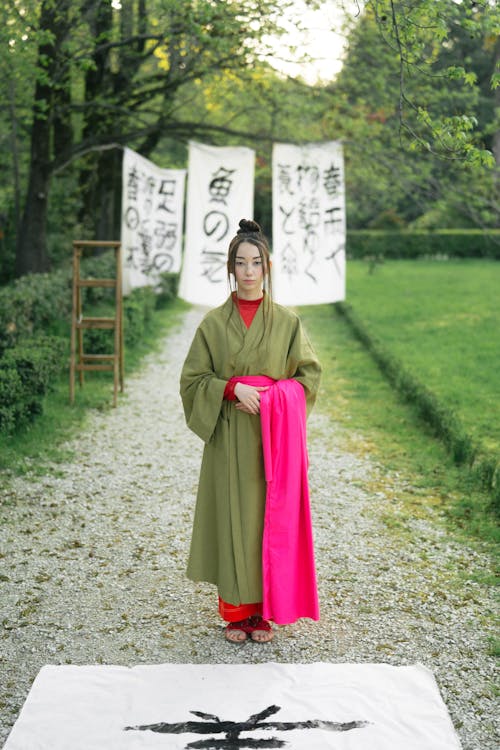 Woman in Green Kimono Standing On Pathway