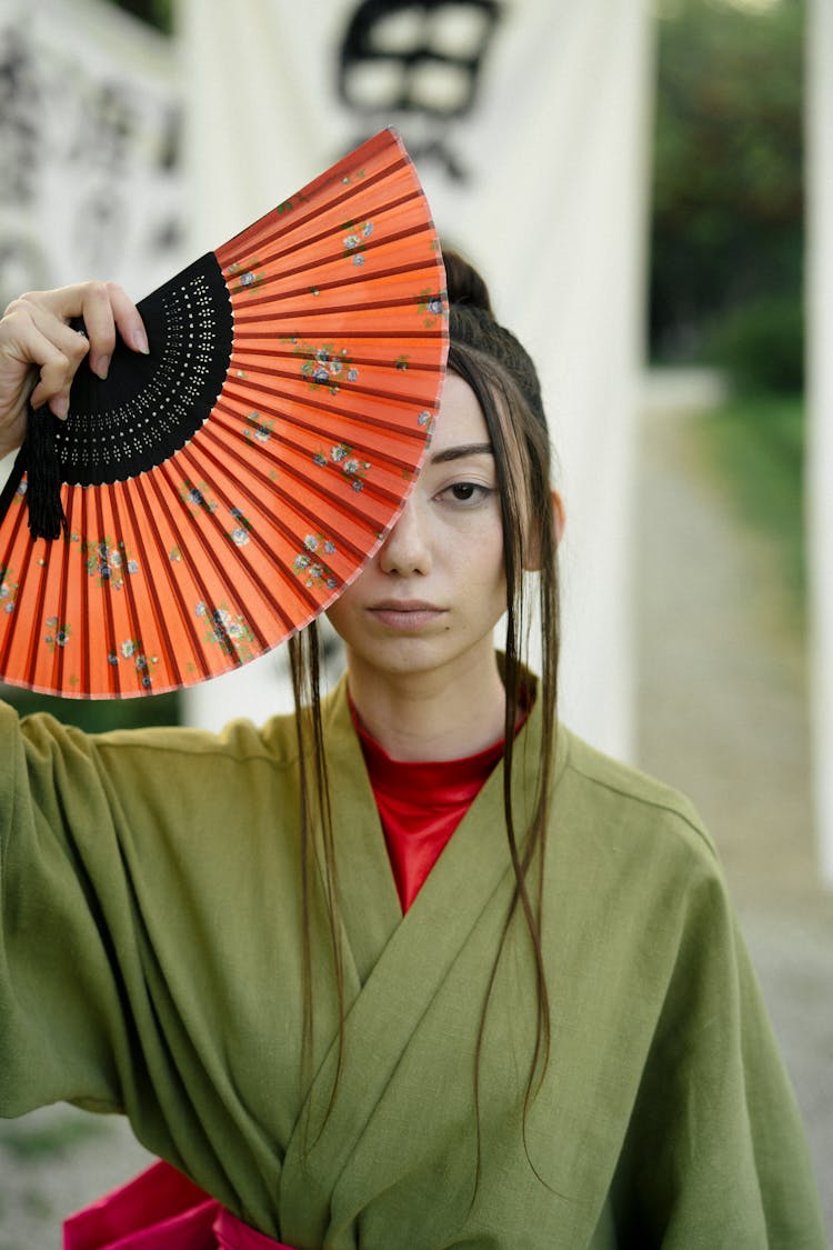 Woman In Green Kimono Holding Hand Fan