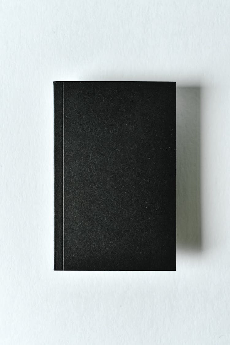 Black Journal On White Surface 