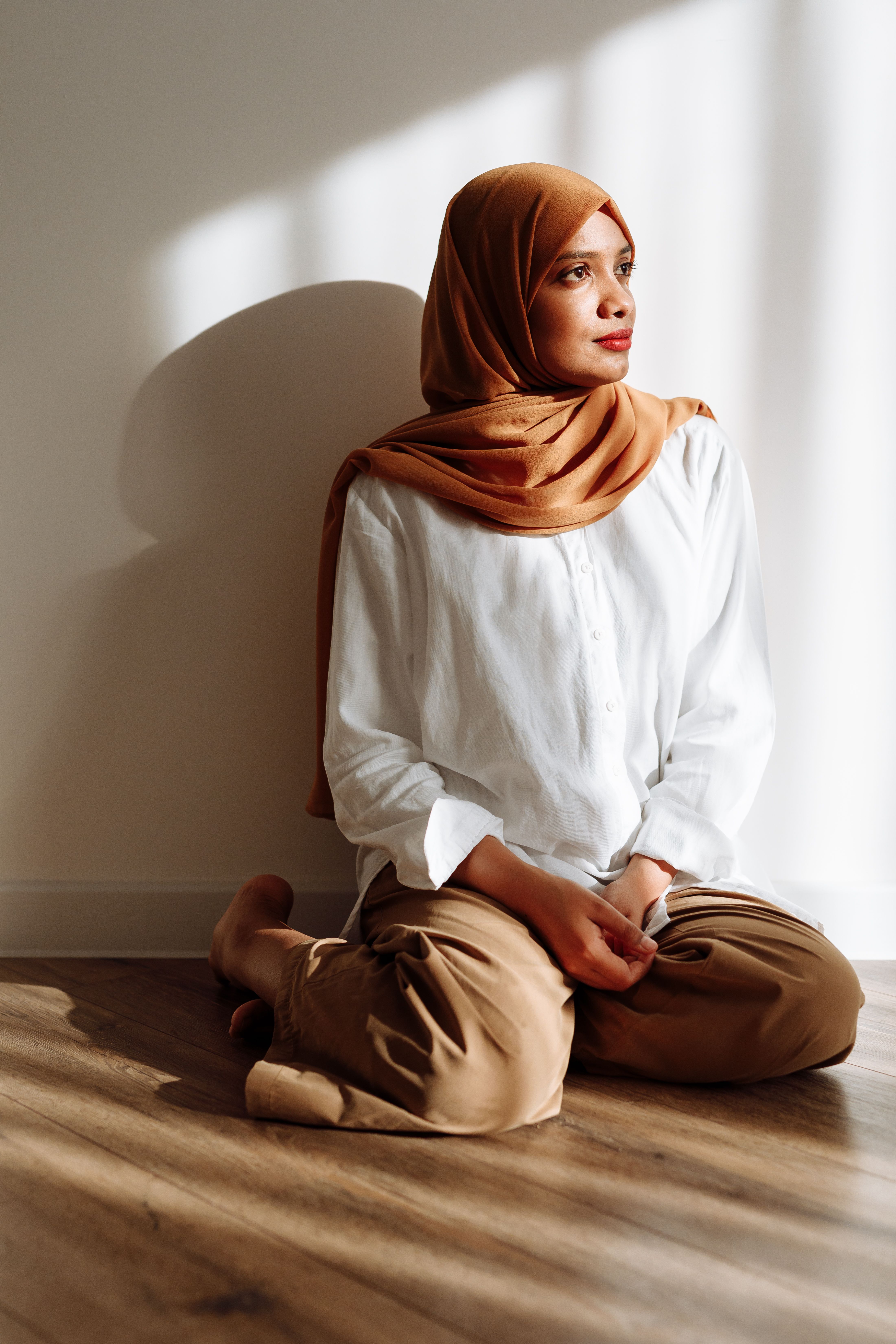 A Woman Wearing a Hijab Sitting on the Floor · Free Stock Photo