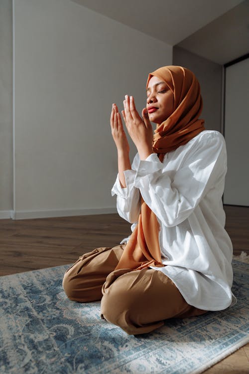 Woman Praying With Her Eyes Closed at Home