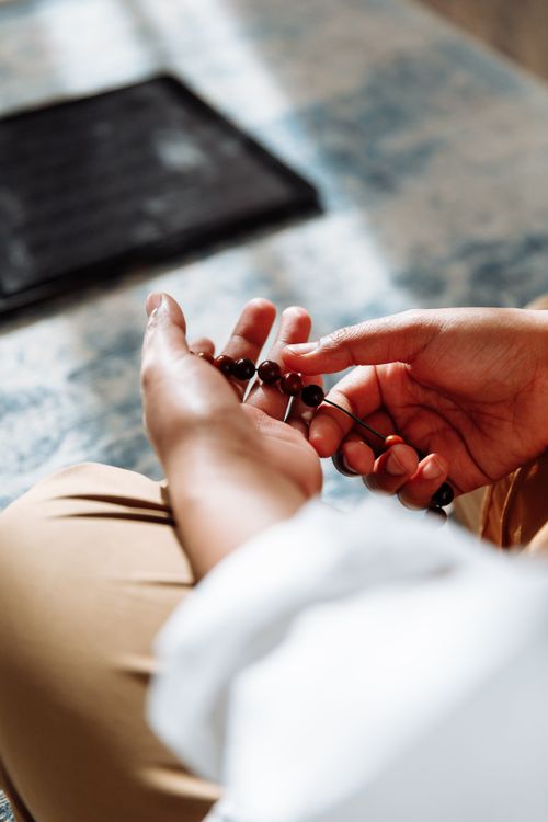 Man Praying with Prayer Beads · Free Stock Photo