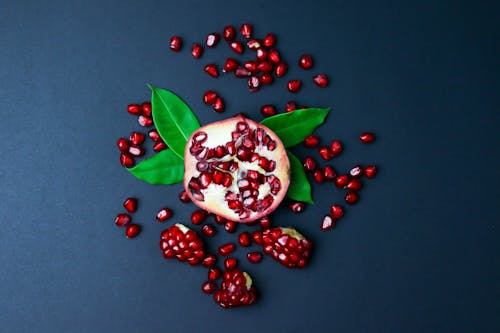 Free Pomegranate on Blue Surface Stock Photo