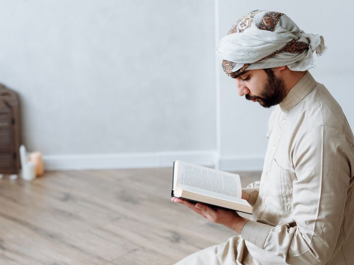 Muslim man reading the Quran