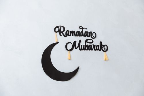 Free Minimalist Ramadan Mubarak decoration with crescent on a light wall background. Stock Photo